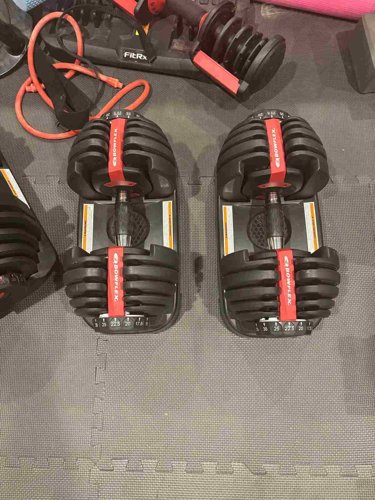 Bowflex SelectTech 552s in cradles with SelectTech 1090s placed diagonally for heavy pickups, FitRx tray also visible — site owner’s owned gear